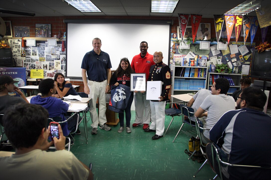 Jacklyn Mireles of Pomona High School is presented her welcome kit as part of her selection to the Semper Fidelis All-American Athlete Program. Jacklyn is one of the 100 athletes in the nation heading to Washington, D.C. for our Battles Won Academy before her senior year. 
