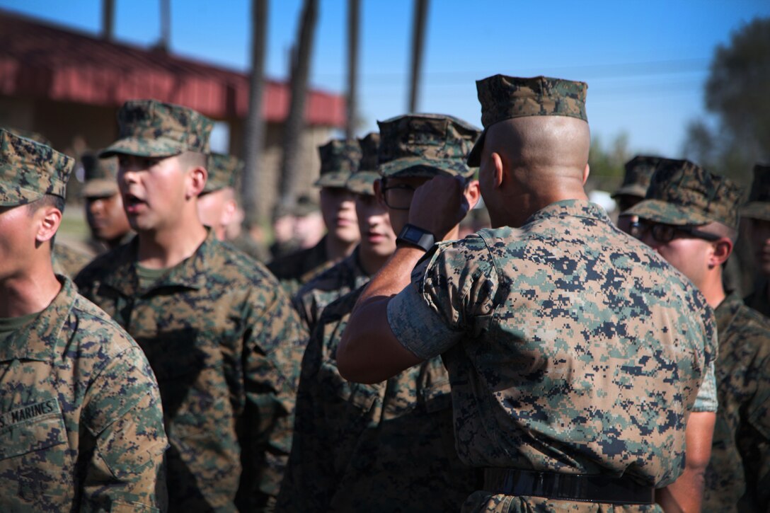 A Drill Instructor instructs an Officer Candidate during the Officer Candidate Annual Pool Function. 