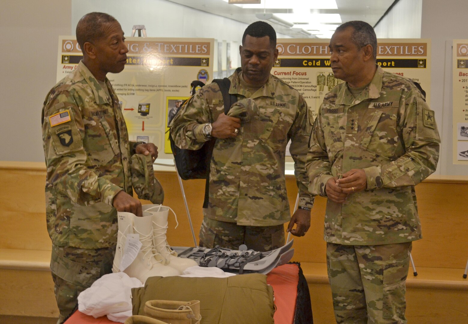 From left to right, Army Brig. Gen. Charles Hamilton, DLA Troop Support commander; Sgt. Maj. Edward Bell, Army G4 senior enlisted advisor; and Lt. Gen. Aundre Piggee, Army deputy chief of staff G4, discuss cold weather boots and other materials that Troop Support’s Clothing and Textiles supply chain provides to the Army. Piggee and Bell visited Troop Support in Philadelphia June 5. 