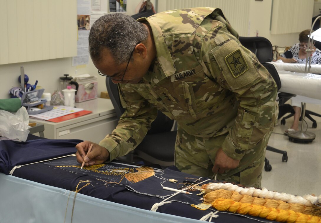 Army Lt. Gen. Aundre Piggee, the deputy chief of staff for Army G4, signs a presidential flag June 5 during a visit to DLA Troop Support’s flag room, where the vice presidential flag and military flags are also made. Piggee got a closer look at how Troop Support’s supply chains support the Army during his visit to Philadelphia.