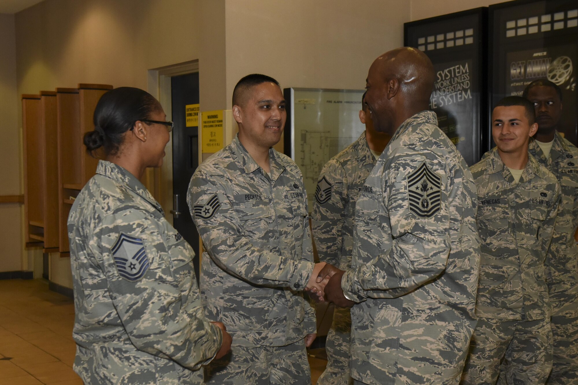 Chief Master Sgt. of the Air Force Kaleth O. Wright awards exceptional performers before an all call with Airmen at Kunsan Air Base, Republic of Korea, June 6, 2017. Wright traveled to Kunsan to meet with airmen and discuss his focus areas as CMSAF as well as the Air Force mission throughout the Pacific region. (U.S. Air Force photo by Senior Airman Michael Hunsaker/ Released)