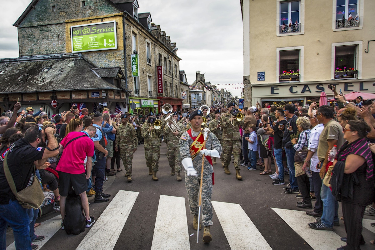 The U.S. Army Europe Band, led by drum major Staff Sgt. Redentor Aledia, marches in a parade in Sainte-Mere-Eglise, France, June 4, 2017, to commemorate the 73rd anniversary of D-Day. Army photo by Spc. Joseph Agacinski