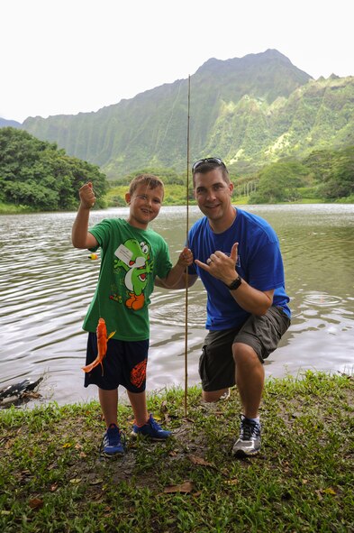 Cooper and his father Capt. John Clason, 535th Airlift Squadron C-17 pilot, pose with one of their fish during the 18th Annual Friends of Hickam Keiki Fishing Tournament in Kaneohe, Hawaii, May 31, 2017.  The tournament is a long-standing tradition that unites the Airmen of the 15th Wing with the Friends of Hickam to build stronger relationships between the base and the community. (U.S. Air Force photo by Tech. Sgt. Heather Redman)