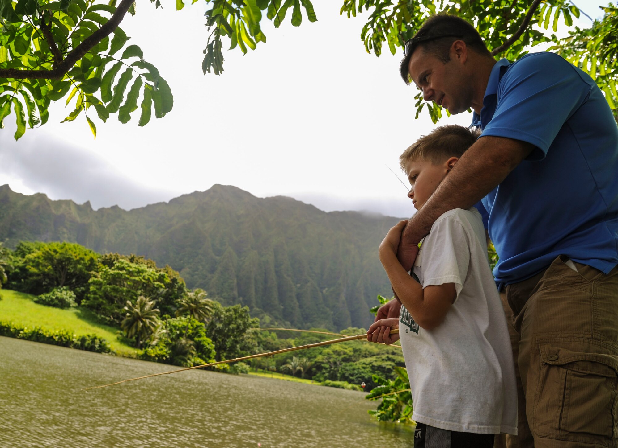 Col. Cavan Craddock, 15th Wing vice commander, helps his son Rett catch fish during the 18th Annual Friends of Hickam Keiki Fishing Tournament in Kaneohe, Hawaii, May 31, 2017.  The tournament is a long-standing tradition that unites the Airmen of the 15th Wing with the Friends of Hickam to build stronger relationships between the base and the community. (U.S. Air Force photo by Tech. Sgt. Heather Redman)