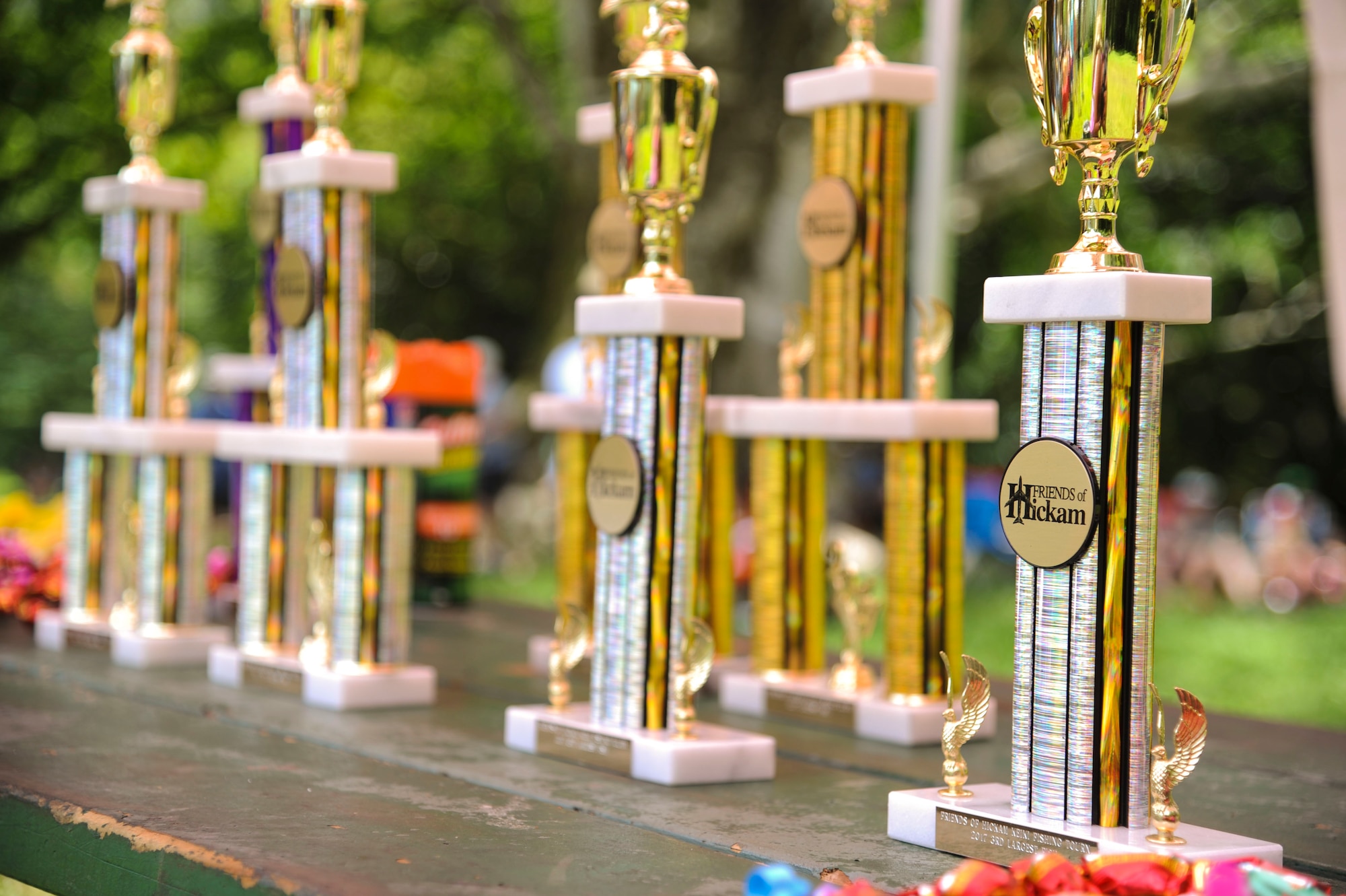 Trophies line a picnic table at the 18th Annual Friends of Hickam Keiki Fishing Tournament in Kaneohe, Hawaii, May 31, 2017. The tournament is a long-standing tradition that unites the Airmen of the 15th Wing with the Friends of Hickam to build stronger relationships between the base and the community. (U.S. Air Force photo by Tech. Sgt. Heather Redman)