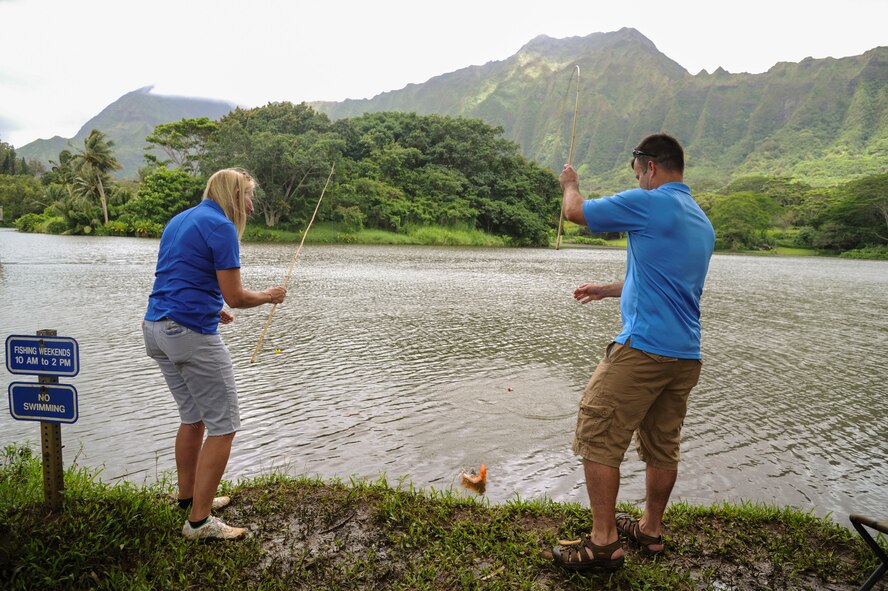 Nicole Darity, president of the Friends of Hickam, and Col. Cavan Craddock, 15th Wing vice commander, compete for the first catch at the 18th Annual Friends of Hickam Keiki Fishing Tournament in Kaneohe, Hawaii, May 31, 2017.  The tournament is a long-standing tradition that unites the Airmen of the 15th Wing with the Friends of Hickam to build stronger relationships between the base and the community. (U.S. Air Force photo by Tech. Sgt. Heather Redman)