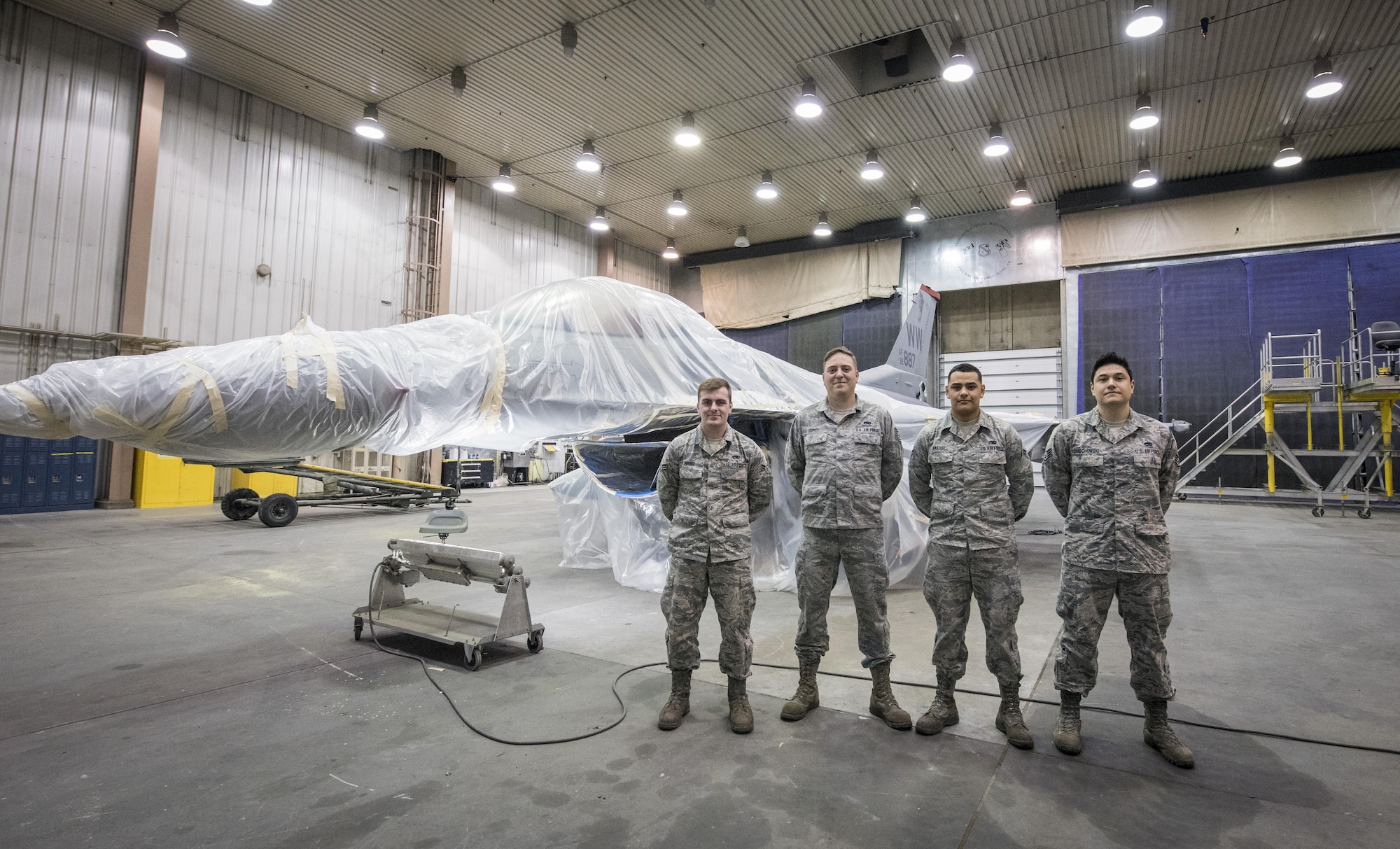 U.S. Air Force Airman 1st Class William Brunz, left to right, Tech. Sgt. Adam Corey, Airman 1st Class Candelario Amador and Staff Sgt. Edward Cimochowski, all 35th Maintenance Squadron aircraft structural maintainers assigned to Misawa Air Base, Japan, stand in front of an F-16 Fighting Falcon at Eielson Air Force Base, Alaska, May 15, 2017. The 35th MXS Airmen developed tactics, techniques and procedures to overcome the paint issue the rest of Pacific F-16 squadrons have since adopted. (U.S. Air Force photo by Tech. Sgt. Araceli Alarcon)