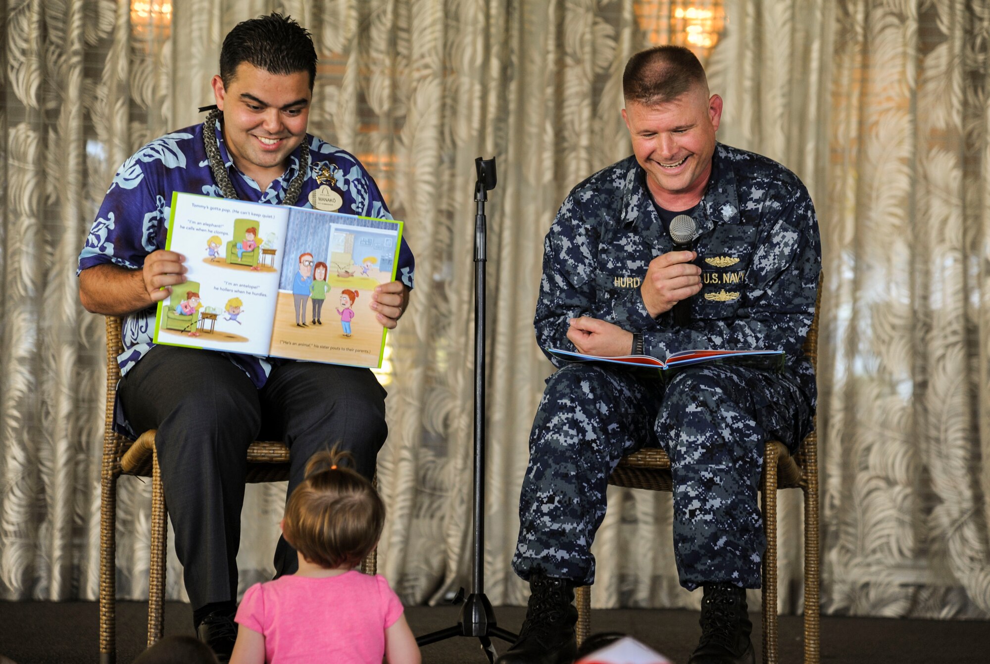 Manko Tamaka, Disney Resort ambassador, and U.S. Navy Commander Corey Hurd, Joint Base Pearl Harbor-Hickam chief staff officer, read Tommy Can’t Stop by Tim Federle during the Books on Bases event at the Hickam Officers Club, hosted by Blue Star Families, Joint Base Pearl Harbor-Hickam, Hawaii, June 2, 2017.  Blue Star Families program donates books to military children, base libraries, Department of Defense schools, and military-impacted public schools and libraries across the world. (U.S. Air Force photo by Tech. Sgt. Heather Redman)