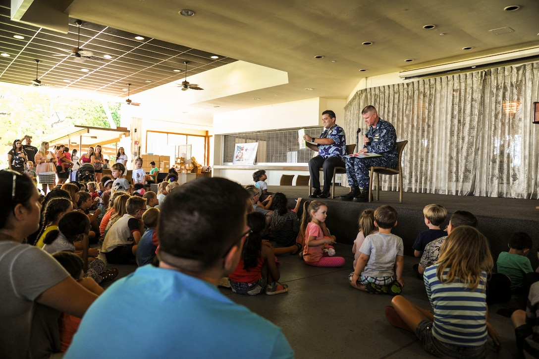 Manko Tamaka, Disney Resort ambassador, and U.S. Navy Commander Corey Hurd, Joint Base Pearl Harbor-Hickam chief staff officer, read Tommy Can’t Stop by Tim Federle during the Books on Bases event at the Hickam Officers Club, hosted by Blue Star Families, Joint Base Pearl Harbor-Hickam, Hawaii, June 2, 2017.  Blue Star Families program donates books to military children, base libraries, Department of Defense schools, and military-impacted public schools and libraries across the world. (U.S. Air Force photo by Tech. Sgt. Heather Redman)