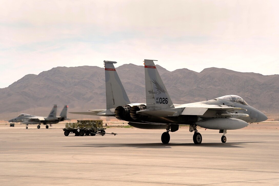 Two Oregon Air National Guard F-15 Eagles taxi along the flightline as they prepare for a sortie at Nellis Air Force Base, Nev., May 31, 2017. Air National Guard photo by Master Sgt. John Hughel