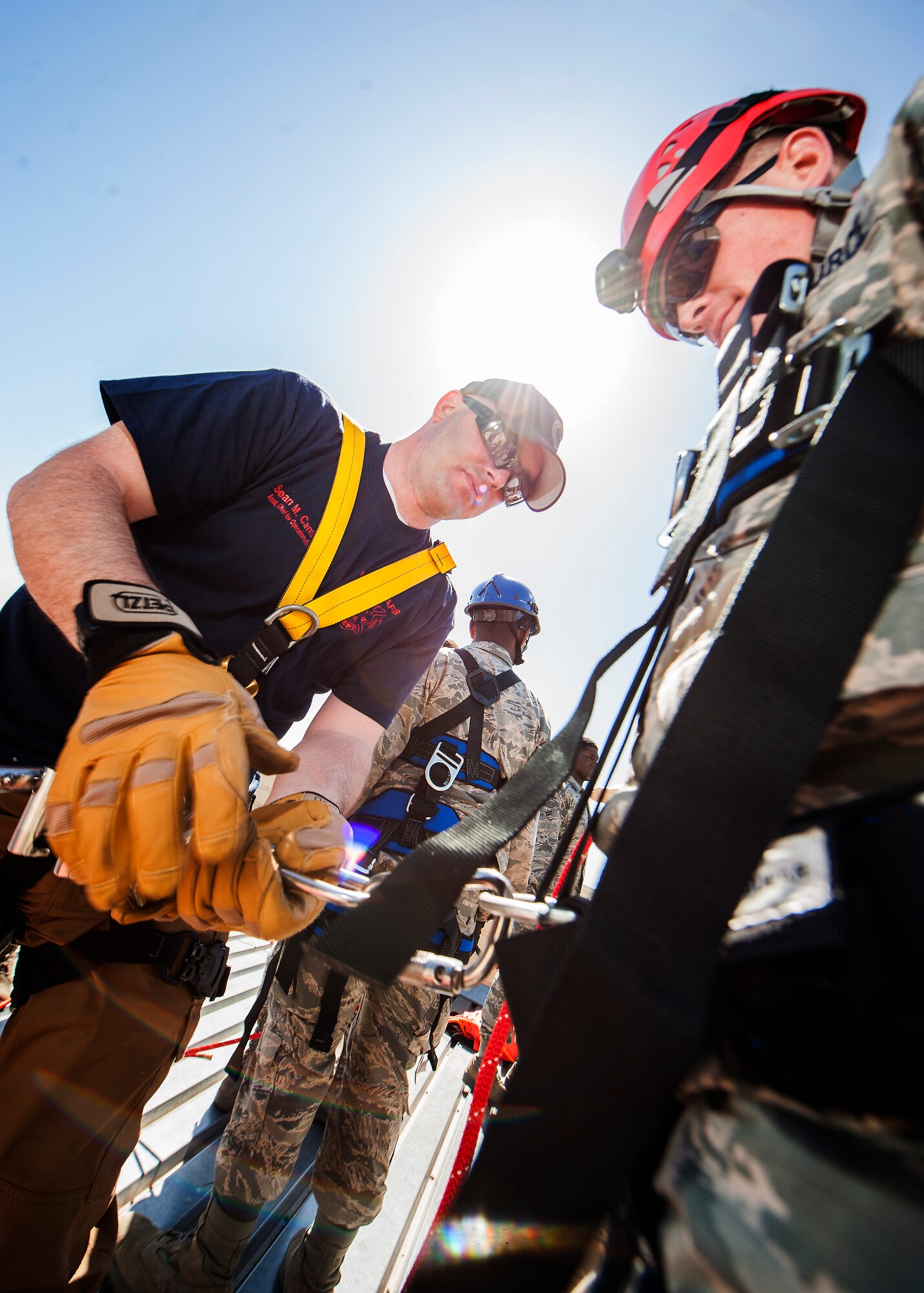 Tech. Sgt. Sean Cantrell, 5th Civil Engineer Squadron assistant chief of operations, secures an Airman’s harness during an Expeditionary Training Day at Minot Air Force Base, N.D., June 1, 2017. More than 60 CE Airmen participated in the training, which consisted of an array of deployment readiness tasks. (U.S. Air Force photo/Senior Airman J.T. Armstrong)