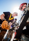 Tech. Sgt. Sean Cantrell, 5th Civil Engineer Squadron assistant chief of operations, secures an Airman’s harness during an Expeditionary Training Day at Minot Air Force Base, N.D., June 1, 2017. More than 60 CE Airmen participated in the training, which consisted of an array of deployment readiness tasks. (U.S. Air Force photo/Senior Airman J.T. Armstrong)