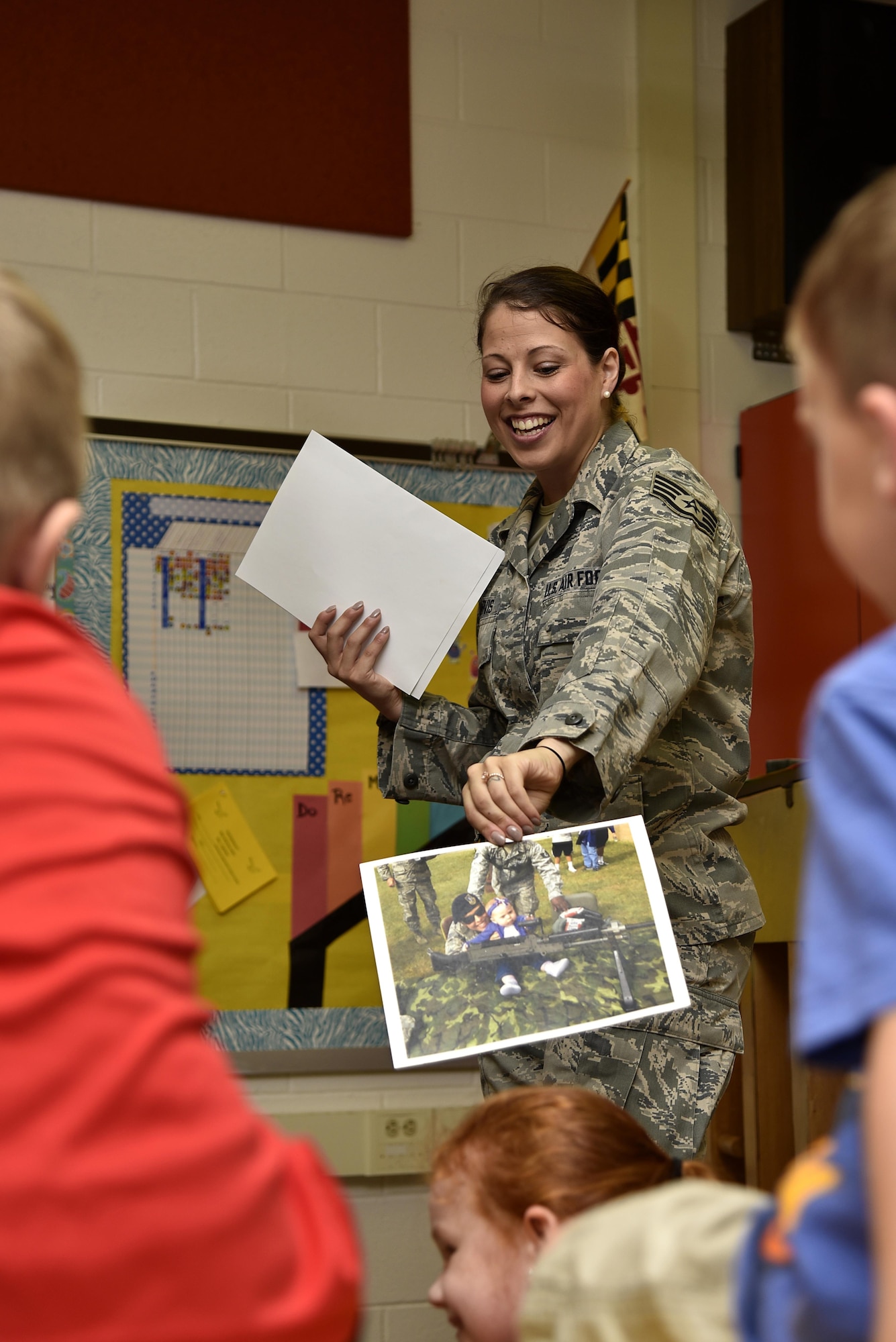 Air Force Staff Sgt. Miriam Y. Jarvis, 175th Force Support Squadron customer service NCO in charge, holds up a photo of herself and her daughter, Avery, June 6, 2017, during a career day presentation at Oliver Beach Elementary School, Middle River, Md.  Jarvis was asked to speak about her job to several classes, including her daughters. (U.S. Air National Guard photo by Airman Sarah M. McClanahan /Released)
