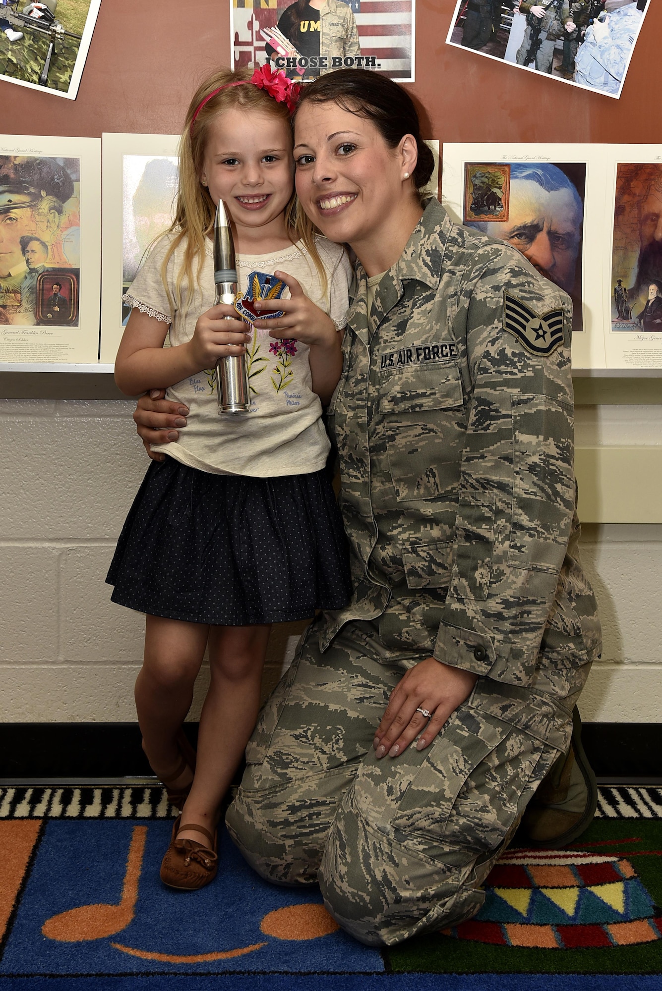 Air Force Staff Sgt. Miriam Y. Jarvis, 175th Force Support Squadron customer service NCO in charge, poses for a photo with her daughter, Avery, June 6, 2017, during a career day presentation at Oliver Beach Elementary School, Chase, Md. Jarvis was speaking to her daughter’s class and other classes about her job during career day. (U.S. Air National Guard photo by Airman Sarah M. McClanahan /Released)