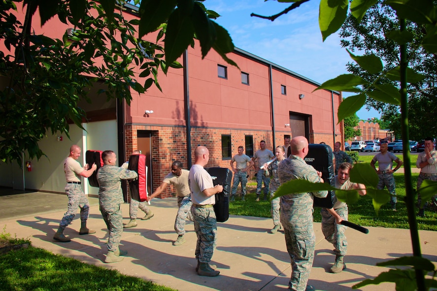 932nd Airlift Wing Security Forces Squadron members with protective shields brace for impact from pressure applied by fellow squadron Airmen during a baton blocking and attacking training class, at Scott Air Force Base, Illinois, June 4, 2017.   Several airmen later volunteered to be in the highly padded RedMan simulation suit to better appreciate the mission and training of the 932nd AW SFS team. It was all about challenging training, unit bonding, and outdoor crowd control and aggressor experience. (U.S. Air Force photo by Lt. Col. Stan Paregien)