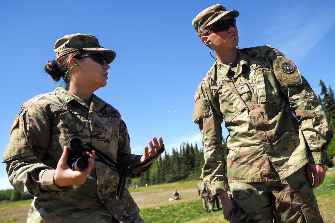 Army Sgt. Selena Sotelo, left, instructs Army Private Donaciano Prado on marksmanship techniques during known distance marksmanship training at Pedneau range at Joint Base Elmendorf-Richardson, Alaska, May 31, 2017. Sotelo and Prado are assigned to the 98th Support Maintenance Company, 17th Combat Sustainment Support Battalion. Air Force photo by Justin Connaher