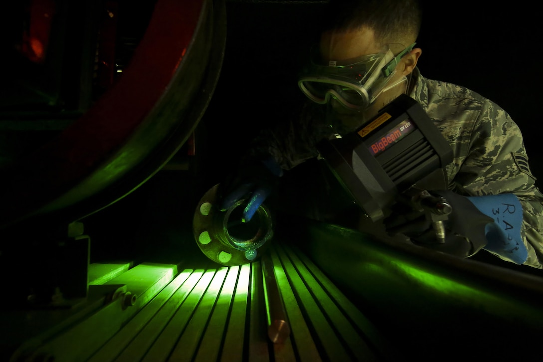 U.S. Air Force Senior Airman Ronald Anazco from the 108th Maintenance Squadron nondestructive inspection (NDI) shop looks at cracks seen on a KC-135 Stratotanker part during a training session at Joint Base McGuire-Dix-Lakehurst, N.J., April 22, 2017. NDI airmen have a variety of technological techniques at their disposal, from fluorescent penetrant to magnetic particle and eddy current testing. (U.S. Air National Guard photo by Master Sgt. Matt Hecht/Released)