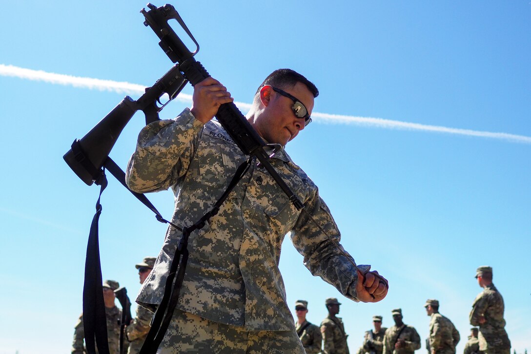 Army Staff Sgt. Rudy Flores cleans his weapon participate in known distance marksmanship training at Pedneau range at Joint Base Elmendorf-Richardson, Alaska, May 31, 2017. Flores is assigned to the 98th Support Maintenance Company, 17th Combat Sustainment Support Battalion. Air Force photo by Justin Connaher