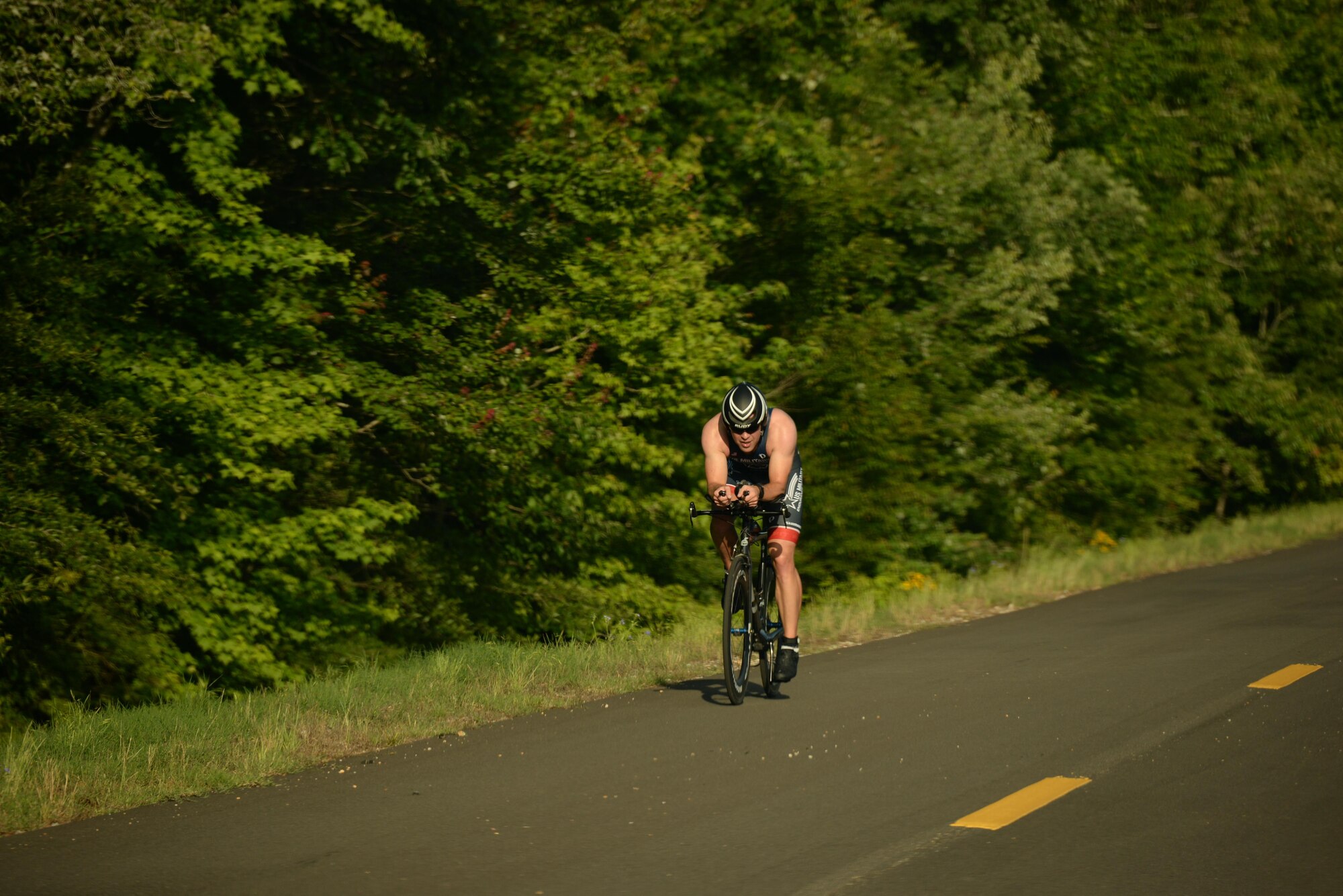 Maj. Alan Goncalves, 50th Flying Training Squadron Assistant Director of Operations, rides down Perimeter Rd. during a triathlon June 3, 2017, on Columbus Air Force Base, Mississippi. Goncalves finished the 22-kilometer bike ride in 35:24. He also finished overall in 1st with a time of 1:03:05. (U.S. Air Force photo by Airman 1st Class Keith Holcomb)