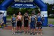 Five triathlon competitors pose for a photo June 3, 2017, in front of the start/finish line on Columbus Air Force Base, Mississippi. Every individual who participated in the full event had the chance to bike down the center runway, an unusual opportunity for most spouses and base staff. (U.S. Air Force photo by Airman 1st Class Keith Holcomb)