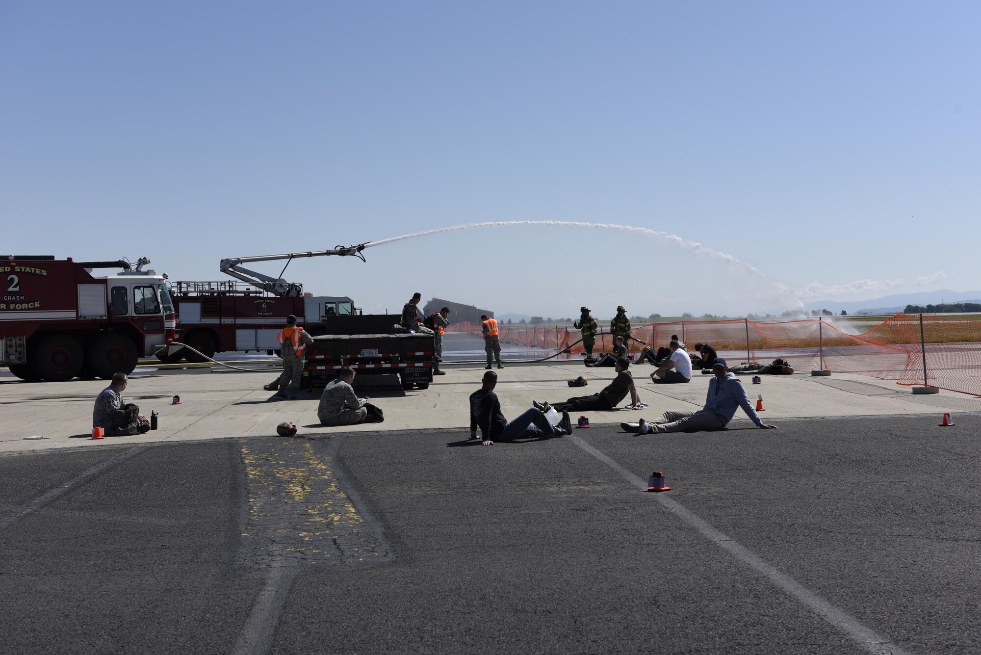 Fire fighters from the 92nd Civil Engineer Squadron spray water onto a simulated fire June 5, 2017, at Fairchild Air Force Base, Washington. Fairchild and local emergency personnel responded to simulated airplane crashes in preparation for Fairchild’s upcoming 2017 SkyFest Air Show. (U.S. Air Force Photo/Airman 1st Ryan Lackey)