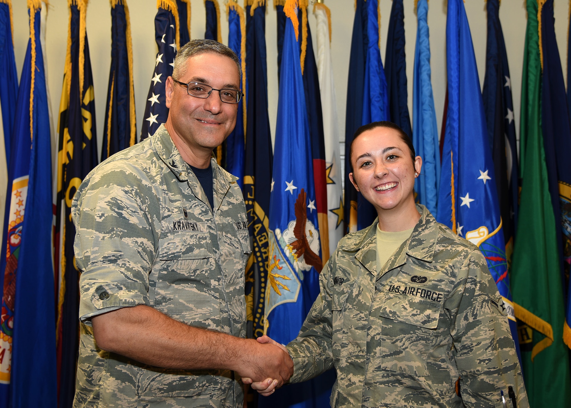 Col. Stephen Kravitsky, 90th Missile Wing commander and Airman Katrina Minor, 90th Missile Wing legal office paralegal, pose for a photo after spending the day together at F.E. Warren Air Force Base, Wyo., June 2, 2017. The shadowing program allows junior Airmen to accompany the commander for a day to learn how senior leaders lead the wing, tackle issues and make critical decisions. (U.S. Air Force Photo by Glenn Robertson)