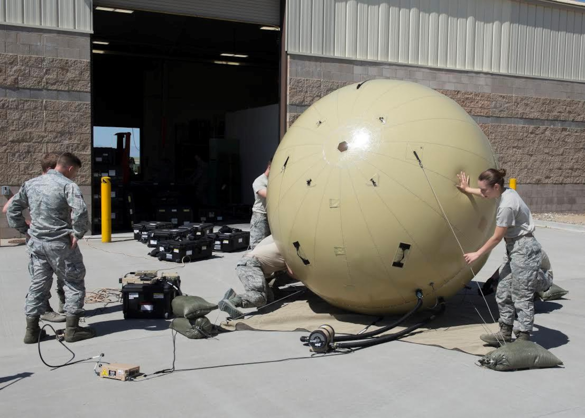 Members of the 726th Air Control Squadron assemble a Small Communications Package May 30, 2017, at Mountain Home Air Force Base, Idaho.  The inflatable system allows smaller teams to transport and employ it without relying on outside agencies. (U.S. Air Force photo by Airman 1st Class Jeremy D. Wolff/Released)