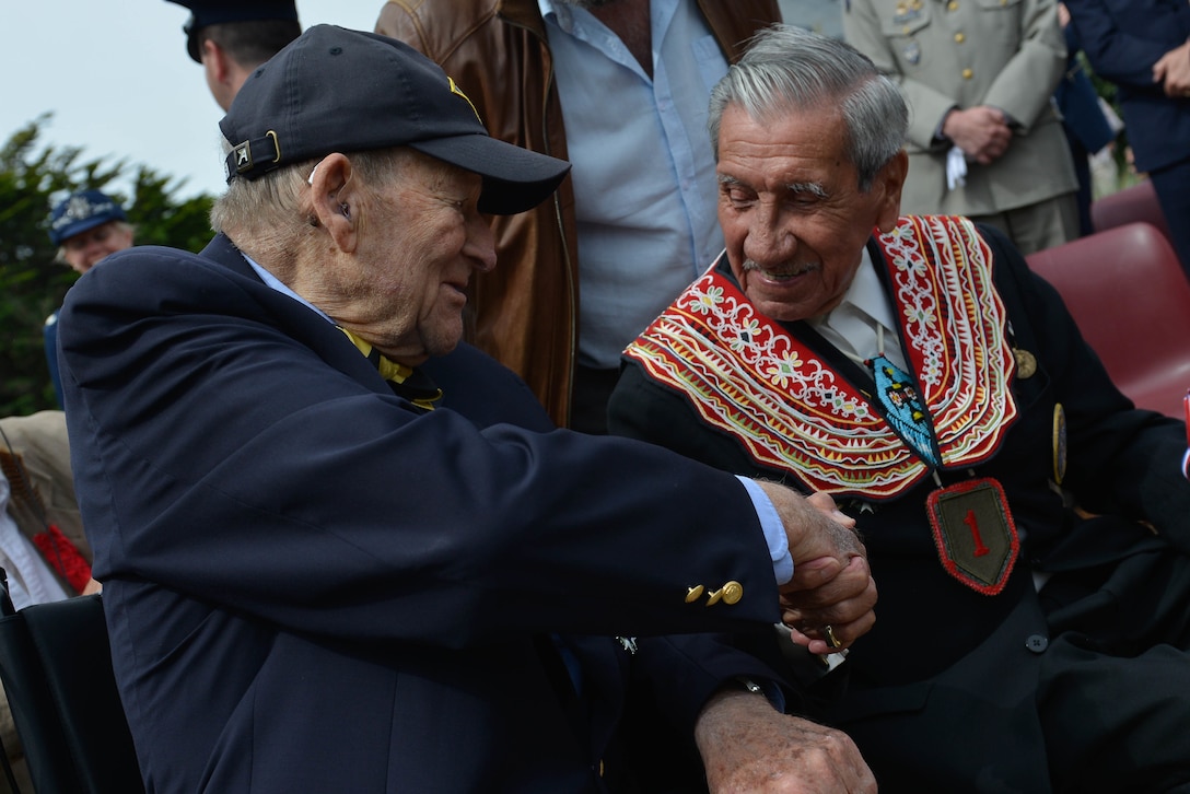 D-Day veterans George Kline and Charles Shay shake hands at the dedications ceremony for the Charles Shay Memorial in Saint-Laurent-sur-Mer, France, June 5, 2017. DoD photo by Air Force Airman 1st Class Alexis C. Schultz