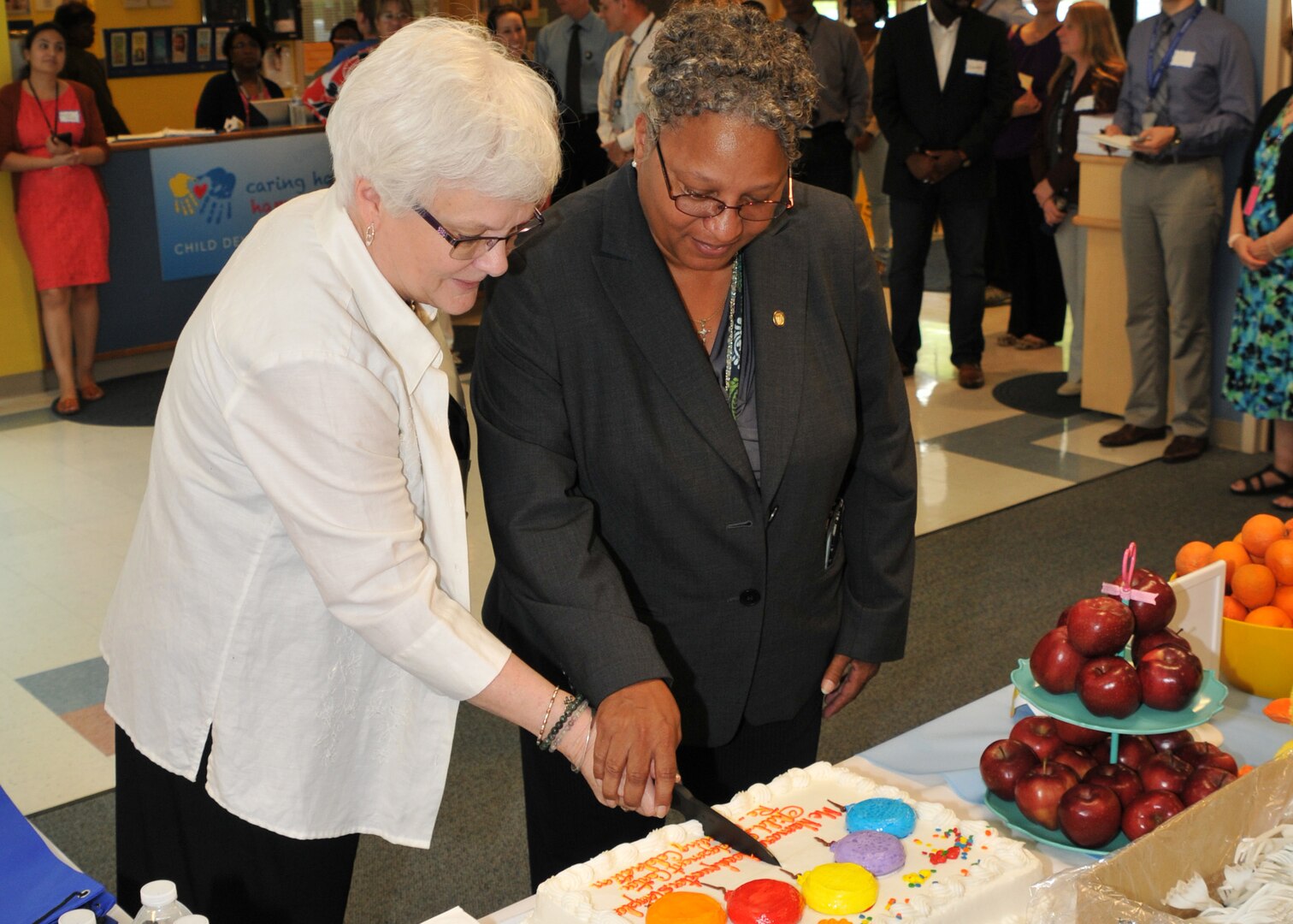 New DLA Headquarters Child Development Center Director Wendy Paul and DLA Chief of Staff Renee Roman cut the cake at the official reopening of the CDC at Fort Belvoir, Virginia, June 5. Photo by Teodora Mocanu.