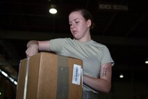 Airman Kylee Boice, 2nd Logistics Readiness Squadron Traffic Management Office receiving technician, checks a package that just arrived at Barksdale Air Force Base, La., June 6, 2017. TMO is split into three sections: cargo movement, personal property and passenger travel. (U.S. Air Force photo/Airman 1st Class Stuart Bright)