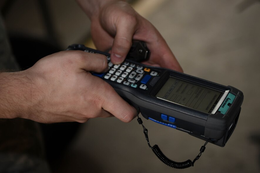 Airman 1st Class Landon Bridges, 2nd Logistics Readiness Squadron Traffic Management Office receiving technician, uses a barcode scanner to check packages at Barksdale Air Force Base, La., June 6, 2017. TMO technicians help people move by providing necessary paperwork needed to have personal property shipped. (U.S. Air Force photo/Airman 1st Class Stuart Bright)