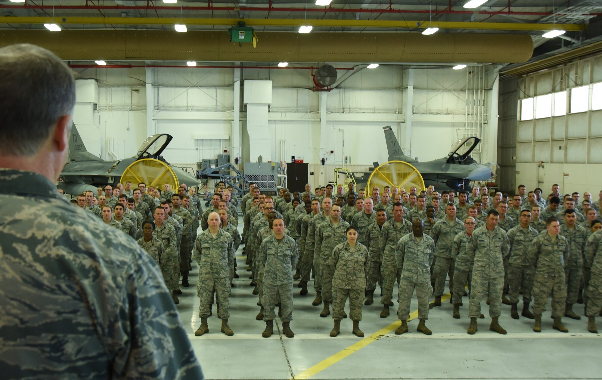 NAVAL AIR STATION FORT WORTH JOINT RESERVE BASE, Texas -- Colonel Gregory Jones, 301st Fighter Wing commander, addresses 301st Maintenance Group Airmen in the hangar during a commander's call Sunday, June 4, 2017. Commander's calls serve as a direct line of communication from wing leadership to Airmen. (U.S. Air Force photo by Tech. Sgt. Melissa Harvey)