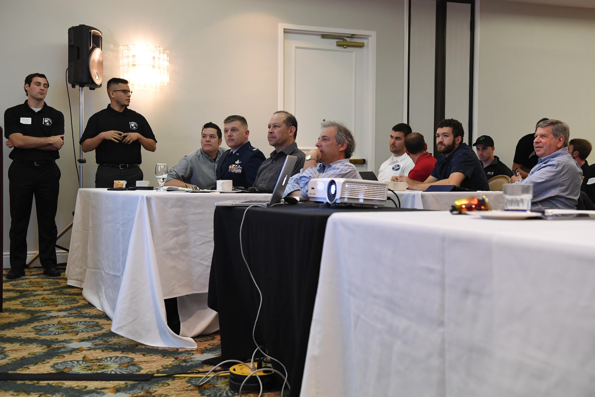 Panelists from the U.S. Department of Defense and commercial space industry listen as California Polytechnic University aerospace engineering students present their satellite design capstone project during a satellite design conference hosted by Cal Poly in Shell Beach, California, June 2, 2017.  The students were responding to a notional solicitation from a fictitious customer that outlined design specifications for a communications and earth-imaging satellite. (U.S. Air Force photo by Capt. Nicholas Mercurio/Released)