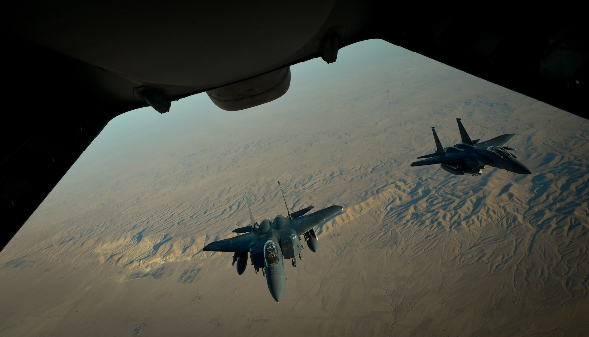 Two U.S. Air Force F-15E Strike Eagles fly in formation after receiving fuel from a 908th Expeditionary Air Refueling Squadron KC-10 Extender during a flight in support of Operation Inherent Resolve June 2, 2017. The F-15E Strike Eagle is a dual-role fighter designed to perform air-to-air and air-to-ground missions. An array of avionics and electronics systems gives the F-15E the capability to fight at low altitude, day or night, and in all weather. (U.S. Air Force photo by Staff Sgt. Michael Battles)