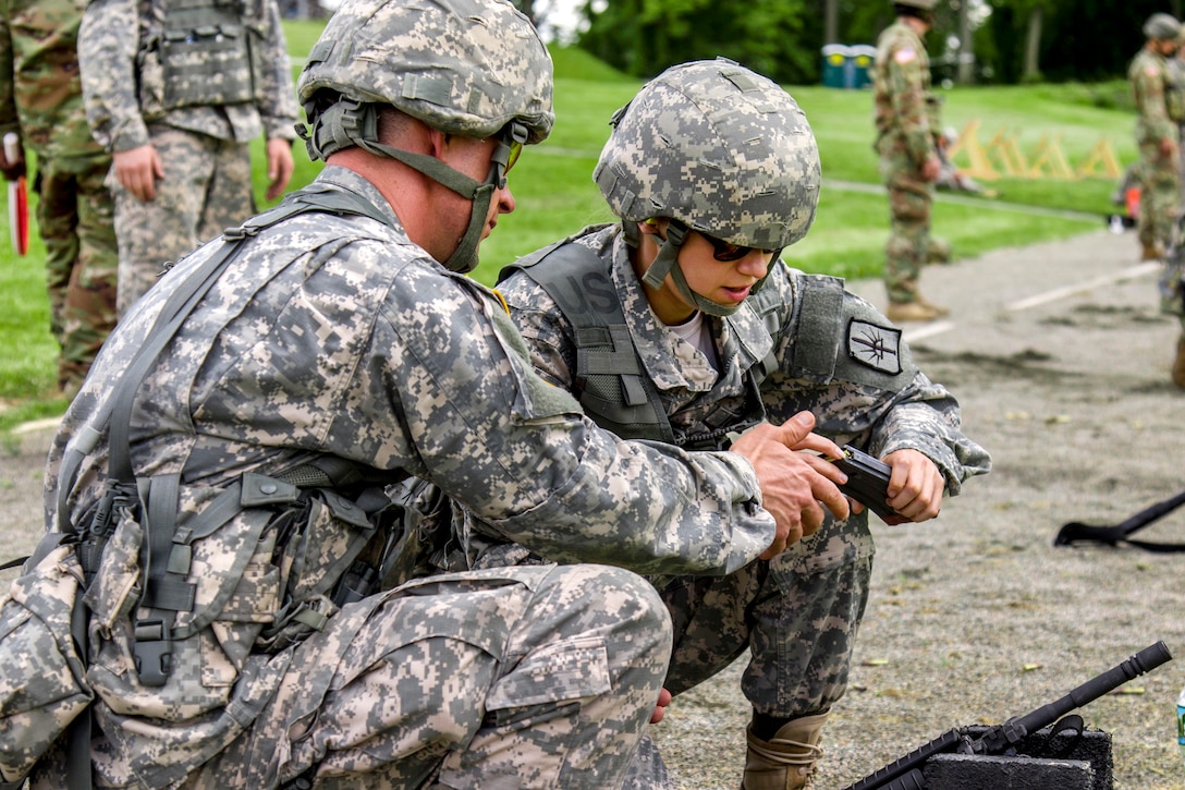 New York Army National Guard Spc. Michael Burton, left, and Army Sgt. Janna Enyart reloads a magazine with 5.56 mm ammunition during a competition at Camp Smith Training Site, N.Y., June 2, 2017. Burton and Enyart are assigned to the 53rd Troop Command. Army National Guard photo by Spc. Jonathan Pietrantoni