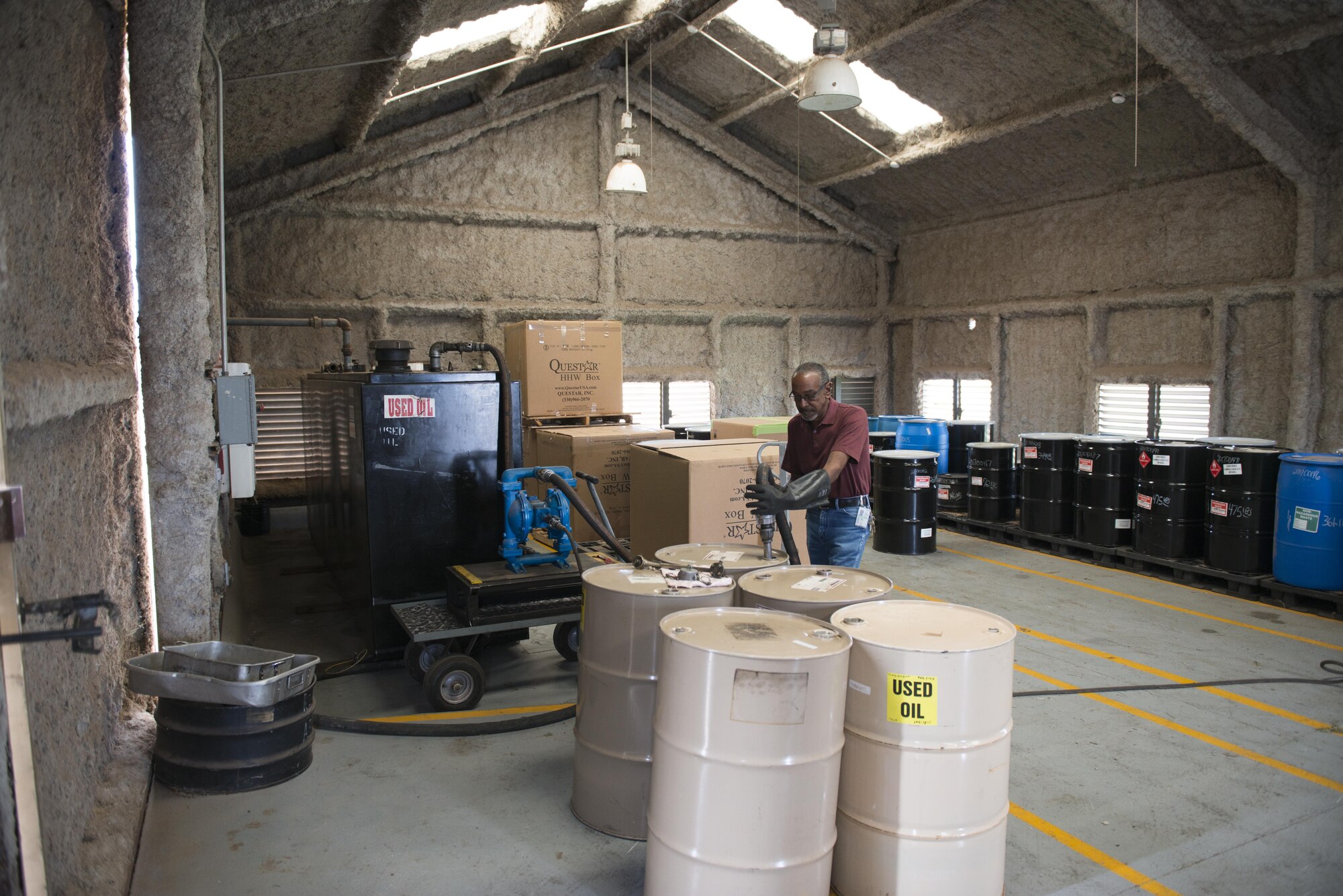 Mr. Floyd Brigham, AFCEC waste contractor with the 7th Civil Engineer Squadron, pumps used oil from a drum at Dyess Air Force Base, Texas, May 3, 2017. The used oil is transferred into a used oil collection tank so it can be recycled while allowing the empty drums themselves to be re-used or recycled, saving the Air Force money. In 2016, approximately 18,000 gallons of used oil and 400 empty drums were recycled.  (U.S. Air Force photo by Senior Airman Austin Mayfield)
