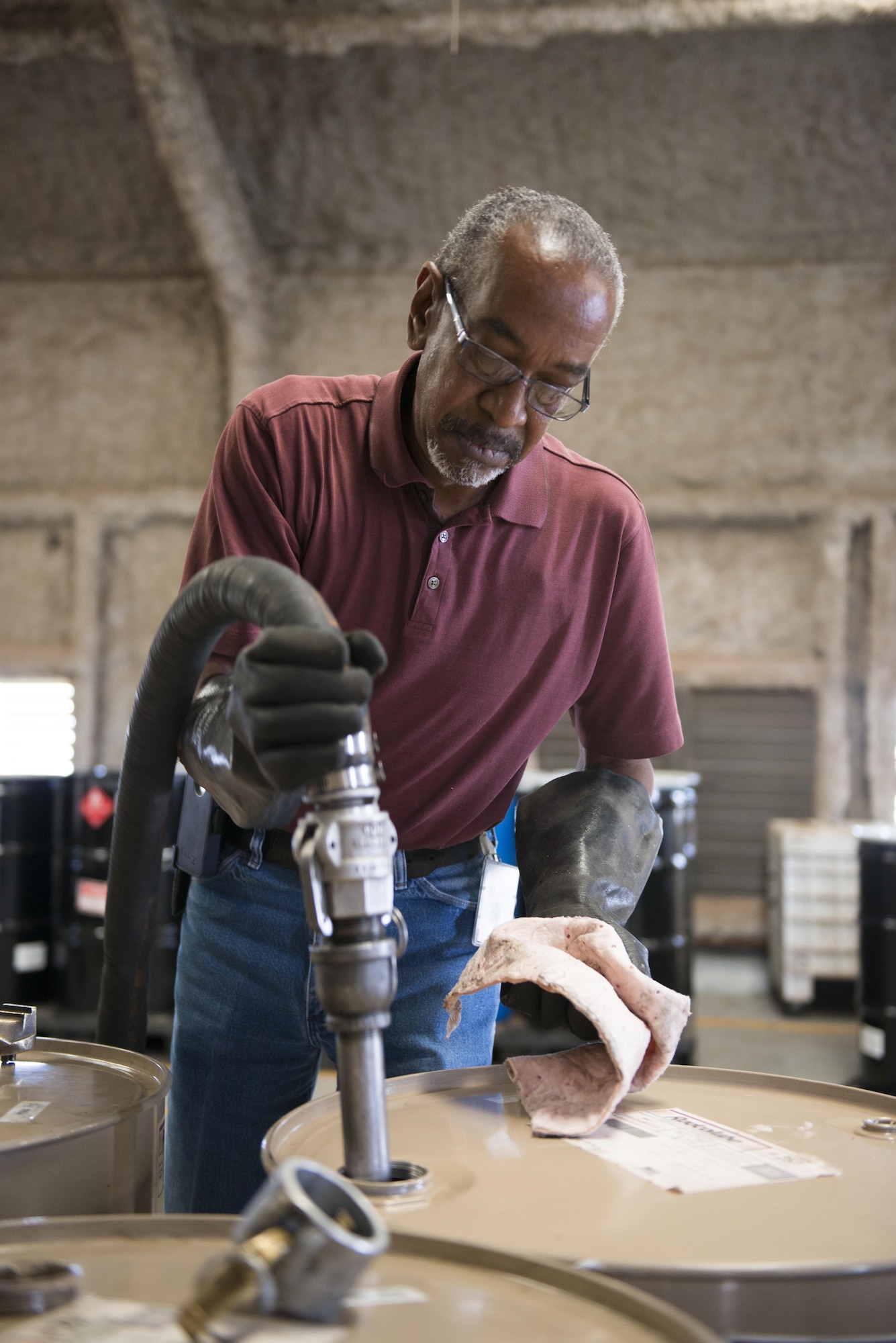 Mr. Floyd Brigham, AFCEC waste contractor with the 7th Civil Engineer Squadron, pumps used oil from a waste drum at a 90-day facility (one of two) at Dyess Air Force Base, Texas, May 3, 2017. A 90-day facility is a regulated building where hazardous and non-hazardous wastes are temporarily stored before being transported off-base for proper disposal at a permitted disposal facility. Dyess AFB properly disposed of more than 82,000 pounds of hazardous and non-hazardous waste in 2016. (U.S. Air Force photo by Senior Airman Austin Mayfield)