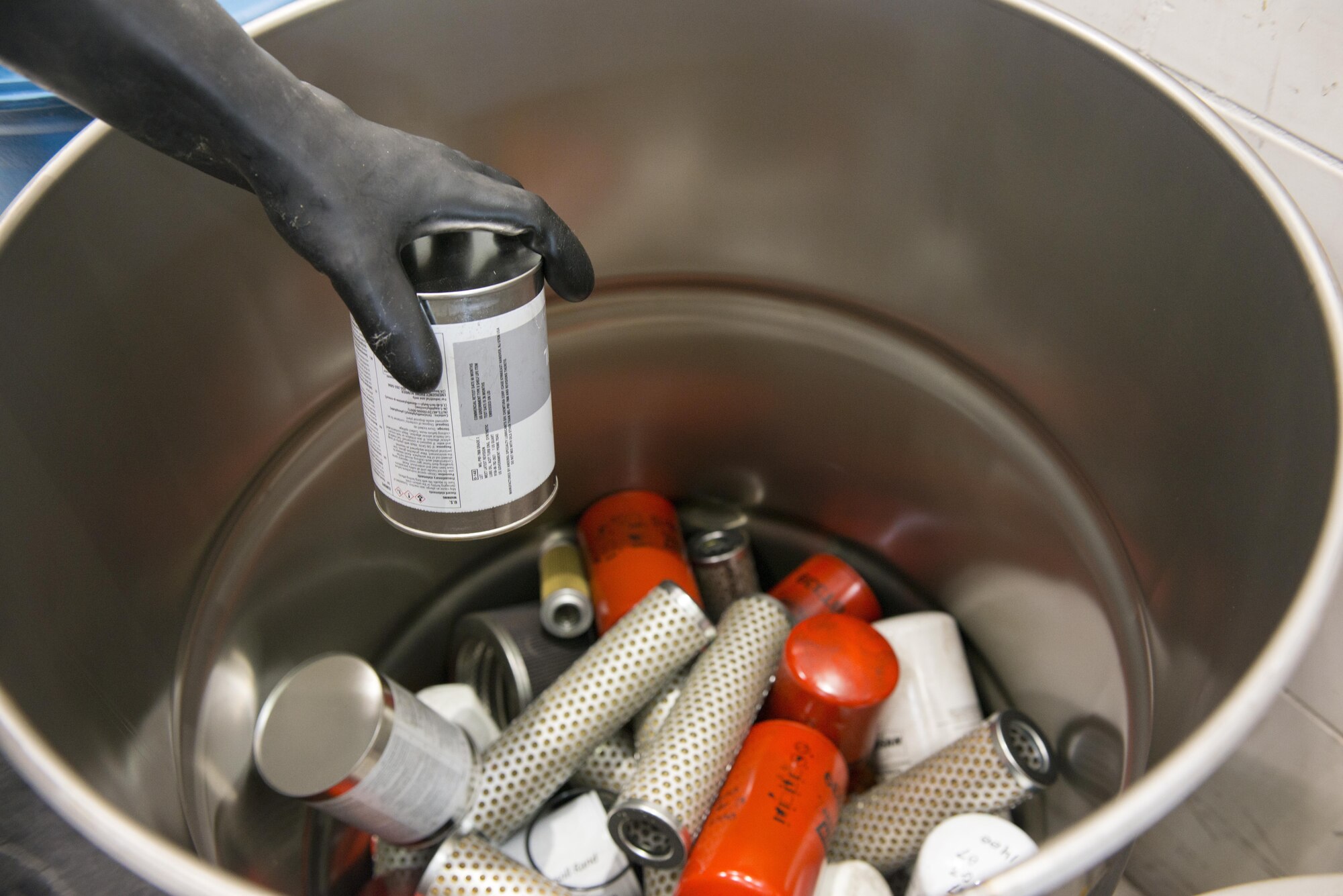 U.S. Air Force Airman 1st Class Steven Melo-Justo, 7th Equipment Maintenance Squadron aerospace ground equipment craftsman, containerizes used oil filters at Dyess Air Force Base, Texas, May 10, 2017.  These used oil filters will be recycled, thus diverting them from being disposed of in a permitted landfill.  In 2016, 3,399 pounds of used oil filters were recycled off base at no charge to the government. (U.S. Air Force photo by Senior Airman Austin Mayfield)