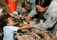 A child receives candy after sampling a Meal Ready-to-Eat during Operation Heroes at Minot Air Force Base, N.D., June 3, 2017. During the event, children tasted Meals Ready-to-Eat, tried on gear, saw weapons displays and created custom-made dog tags. The event concluded with a redeployment line and a welcome home celebration. (U.S. Air Force photo/Senior Airman Sahara L. Fales)