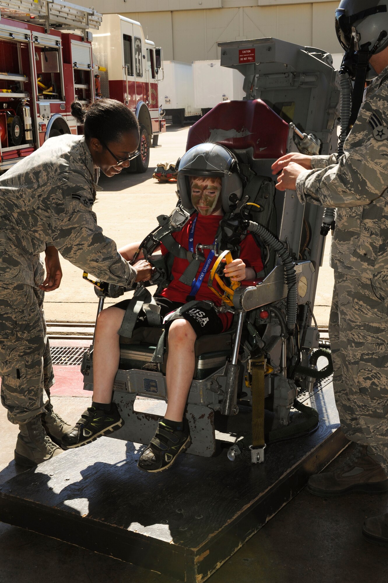 A child sits in an ejection seat during Operation Heroes at Minot Air Force Base, N.D., June 3, 2017. Operation Heroes is an annual event hosted by the 5th Force Support Squadron that allows military children to undergo a mock deployment to help them better understand what their parents experience abroad. (U.S. Air Force photos/Senior Airman Sahara L. Fales)