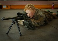 A child looks through a rifle scope during Operation Heroes at Minot Air Force Base, N.D., June 3, 2017. Operation Heroes is an annual event hosted by the 5th Force Support Squadron that allows military children to undergo a mock deployment to help them better understand what their parents experience abroad. (U.S. Air Force photos/Senior Airman Sahara L. Fales)