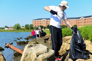 U.S. Air Force Staff Sgt. Dongpyo Yi, 733rd Logistics Readiness Squadron customer service supervisor, gathers trash during the 29th annual Clean the Bay Day at Joint Base Langley-Eustis, Va., June 3, 2017. The volunteer’s efforts affect the Chesapeake Bay, part of which falls along Langley Air Force Base, Va.’s, shoreline, and is one of America’s largest seafood suppliers, according to the National Park Service. (U.S. Air Force photo/Senior Airman Derek Seifert)