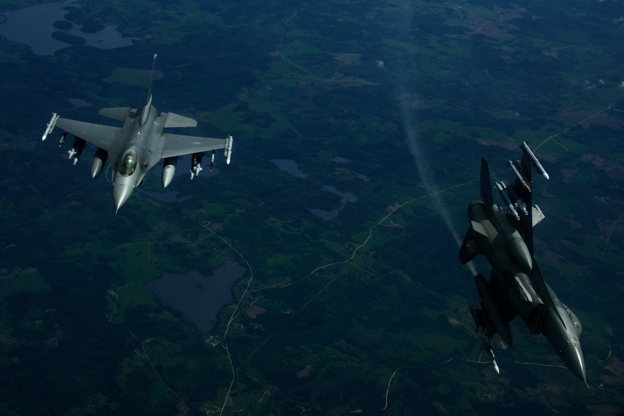 Two F-16 Fighting Falcons, 510th Fighter Squadron, are deployed to Krzesiny Air Base, Poland, in support of
Aviation Detachment rotation 17-3, exercise BALTOPS and exercise Saber Strike fly over Latvia, June 7, 2017. The
exercise, is designed to enhance flexibility and interoperability, to strengthen combined response capabilities, as well as demonstrate resolve among Allied and Partner Nations' forces to ensure stability in, and if necessary defend, the Baltic Sea region. (U.S. Air Force photo by Staff Sgt. Jonathan Snyder)
