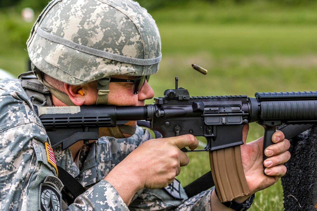 New York Army National Guard Staff Sgt. Michael Kapela fires his M4 carbine during a competition at Camp Smith Training Site, N.Y., June 3, 2017. Kapela is assigned to the 152nd Engineer Support Company. The guardsmen and state militia competed during the Sgt. Henry Johnson Individual Combat Rifle Match, promoting excellence in marksmanship and weapon systems skills in a battle-focused environment. Army National Guard photo by Sgt. Harley Jelis