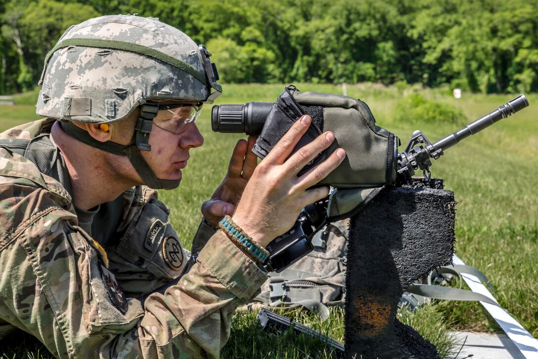 New York Army National Guard Staff Sgt. Ian Ault uses a range designator to check the distance to targets during competition at Camp Smith Training Site, N.Y., June 3, 2017. Ault is an infantryman assigned to Company D, 2nd Battalion, 108th Infantry Regiment. Army National Guard photo by Sgt. Harley Jelis 