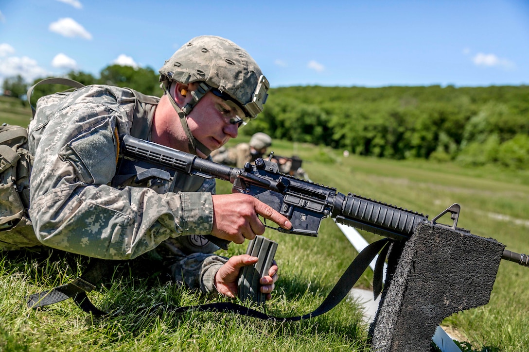 New York Army National Guard Spc. Bryant Pinette prepares to load a magazine into his M4 carbine during a competition at Camp Smith Training Site, N.Y., June 3, 2017. Pinette is assigned to Company D, 2nd Battalion, 108th Infantry Regiment. Army National Guard photo by Sgt. Harley Jelis