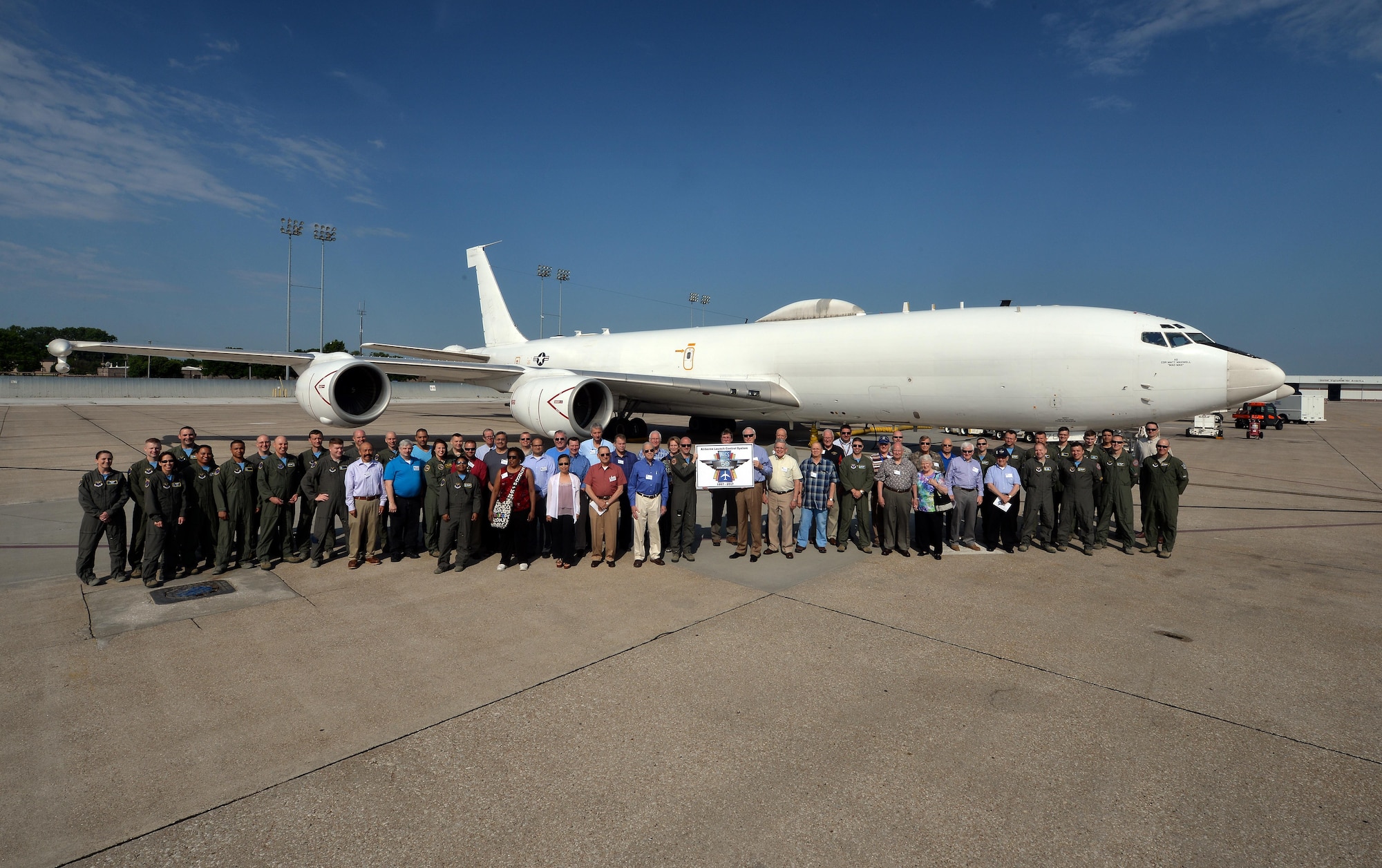 A group of past and present airborne missileers pose in front of an U.S. Navy E-6B Mercury to celebrate the 50th anniversary of the Airborne Launch Control System June 2. During their time here the group received a tour of the jet, a 625th Strategic Operations Squadron mission briefing, ate lunch at the Patriot Club and posed for a photo in front of an EC-135 Looking Glass, which is on static display next to the Kenney Gate (U.S. Air Force photo by Josh Plueger).