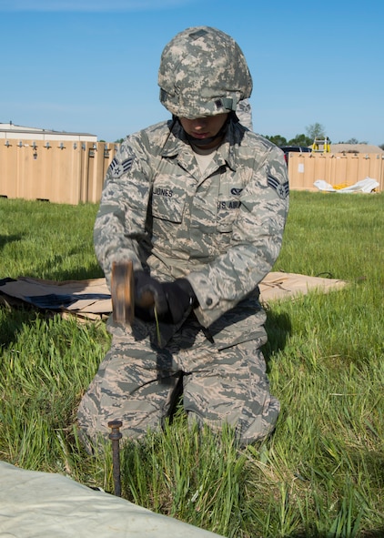 Senior Airman John Jones, 5th Civil Engineer Squadron structural apprentice, hammers a stake into the ground at Minot Air Force Base, N.D., June 1, 2017. The 5th CES built two tents during Expeditionary Training Day to help Airmen prepare for potential deployment. (U.S. Air Force photo/Airman 1st Class Alyssa M. Akers)