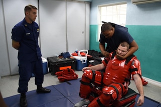 Coast Guard Petty Officer 1st Class Matthew Matheson, a maritime enforcement specialist assigned to the Maritime Law Enforcement Academy in Charleston, South Carolina, observes a member of the Antigua Coast Guard practice a use-of-force technique during exercise Tradewinds 2017 at the Barbados Coast Guard Base in Bridgetown, Barbados, June 6, 2017.  Tradewinds 2017 is a joint, combined exercise conducted in conjunction with partner nations to enhance the collective abilities of defense forces and constabularies to counter transnational organized crime, and to conduct humanitarian/disaster relief operations. U.S. Coast Guard photo by Petty Officer 1st Class Melissa Leake/Released