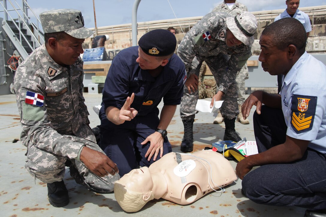 Surgeon Lieutenant Nathaniel Roocroft of the Royal Navy demonstrates how to use a defibrillator during basic first aid familiarization training for Exercise Tradewinds 2017 in Bridgetown, Barbados, June 7, 2017.  Tradewinds 2017 is a joint, combined exercise conducted in conjunction with partner nations to enhance the collective abilities of defense forces and constabularies to counter transnational organized crime, and to conduct humanitarian/disaster relief operations. (Royal Bahamas Defense Force photo by Marine Seaman Michael Turner/Released)